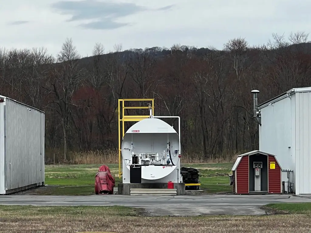 A white truck parked on top of an open field.