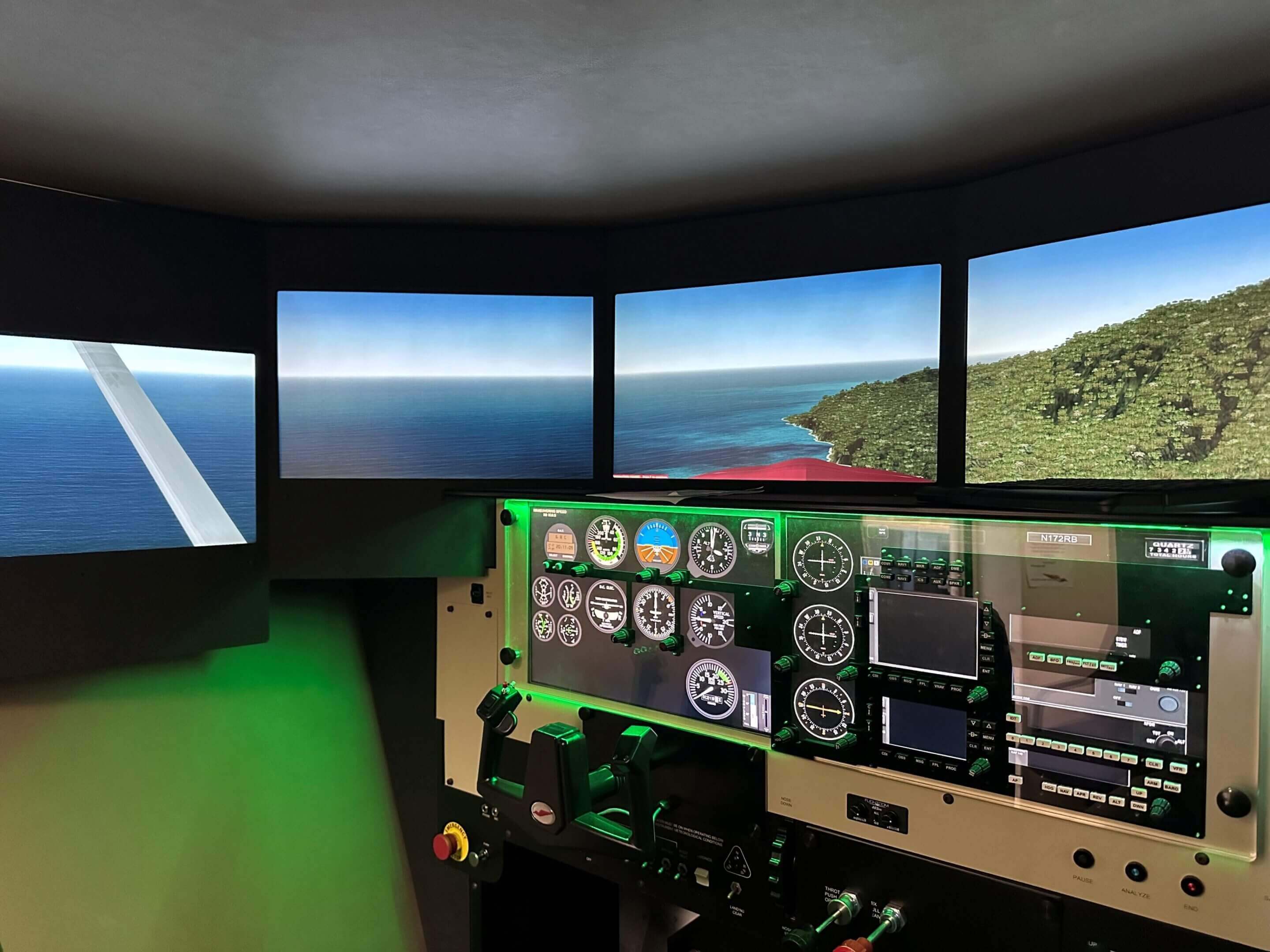 Flight simulator cockpit with ocean view screens.