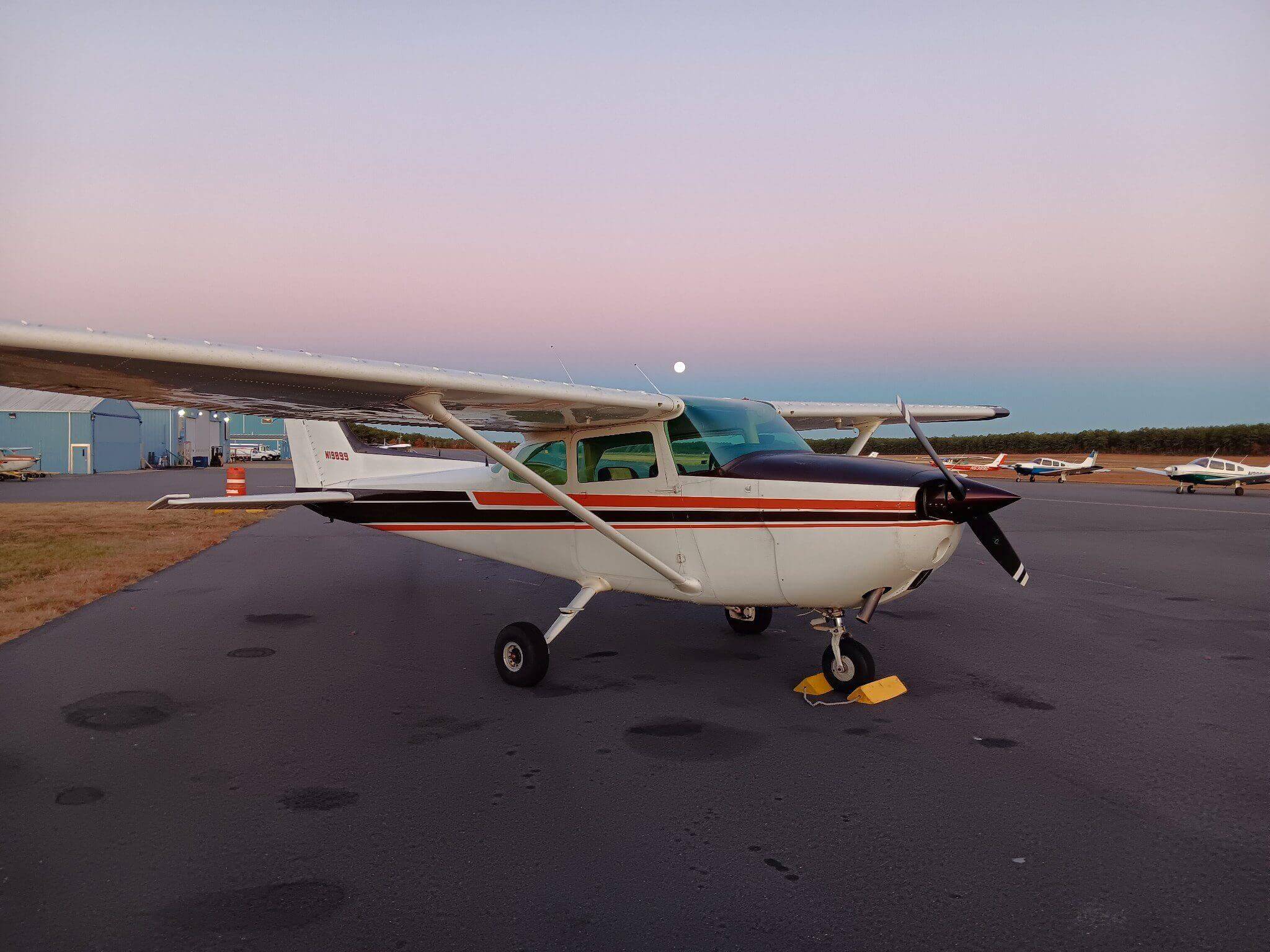 Small airplane parked on airport tarmac.
