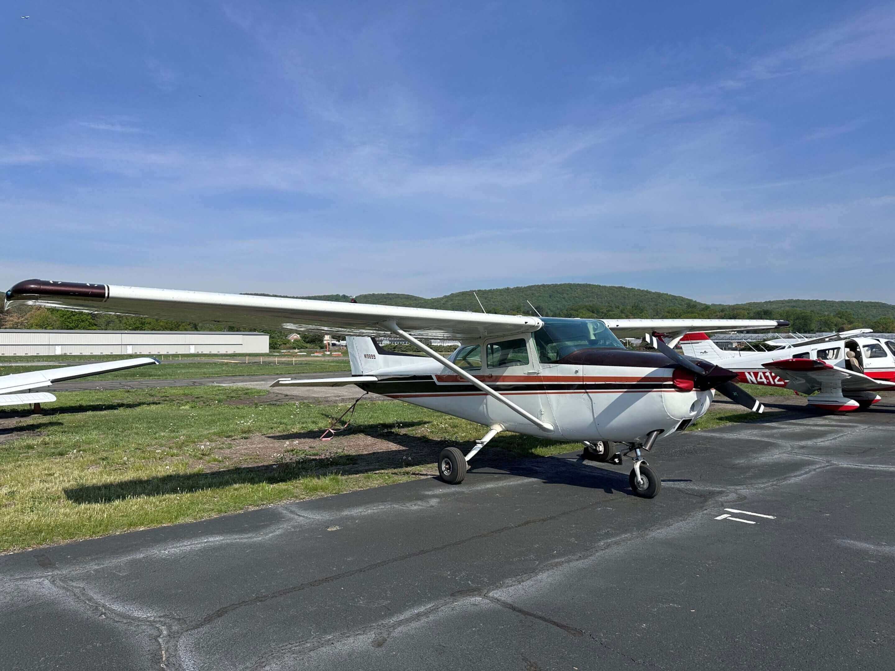 Small aircraft parked on airport tarmac.