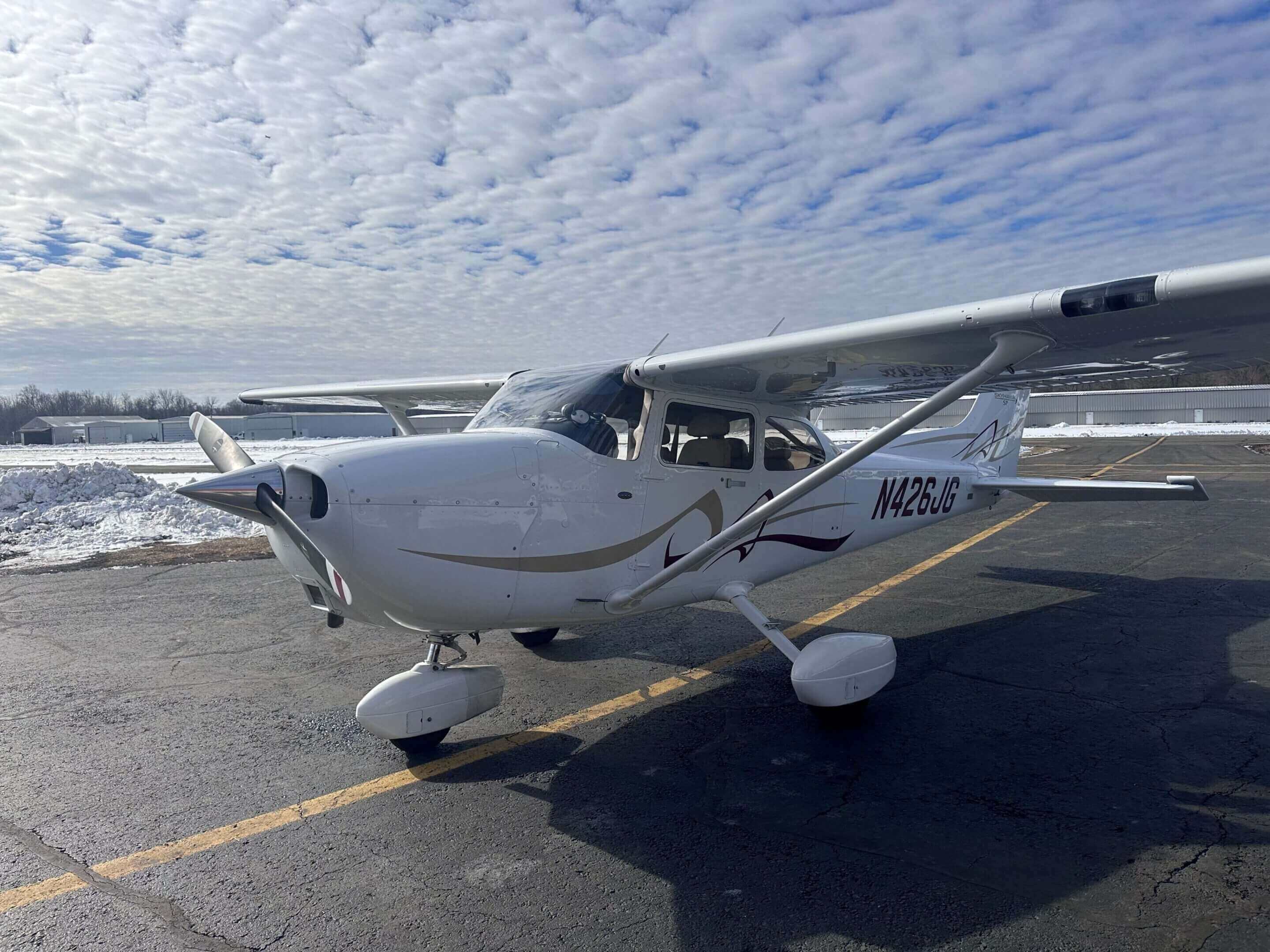 Small airplane on snowy runway.