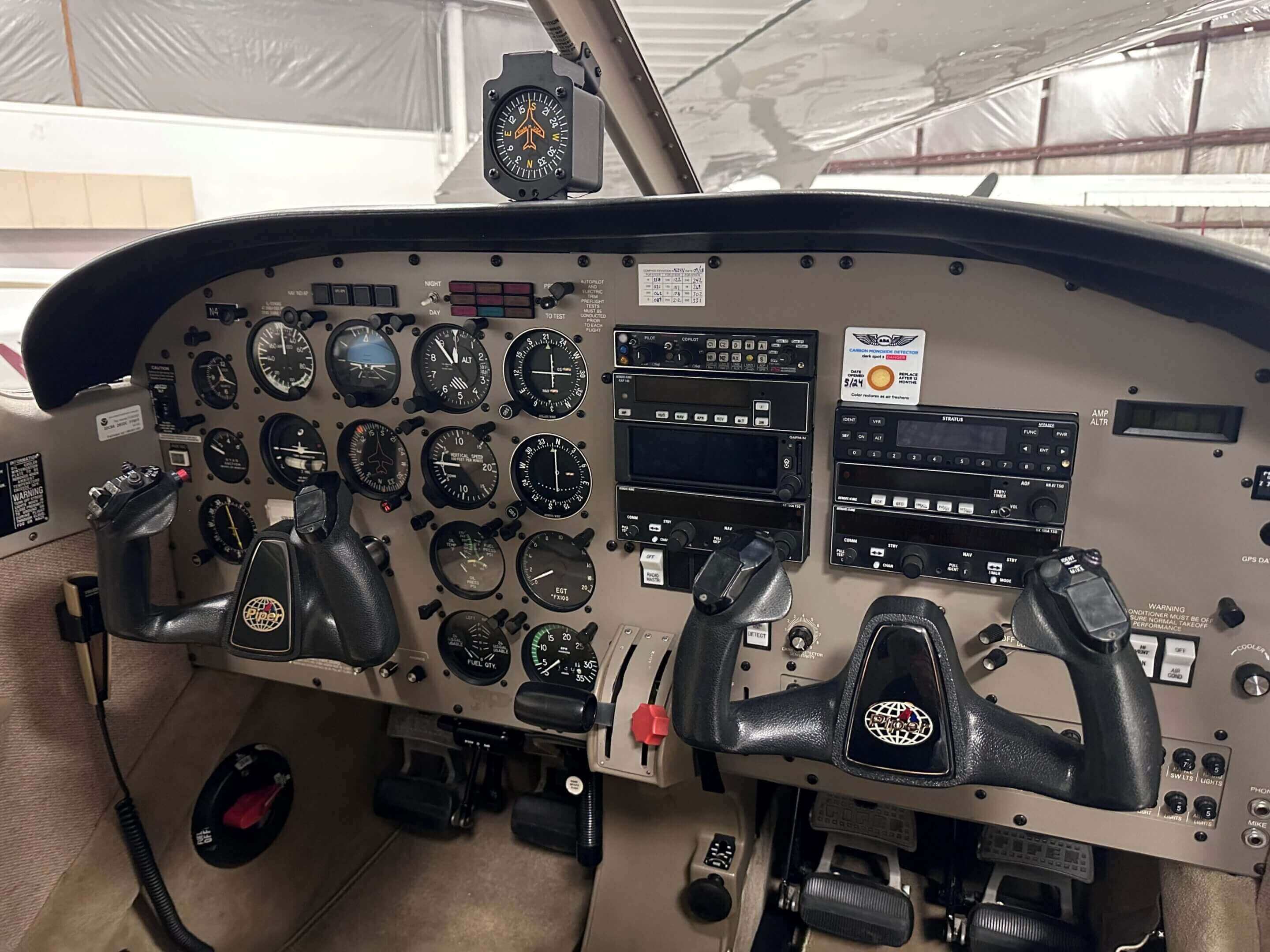 Airplane cockpit with various control instruments.