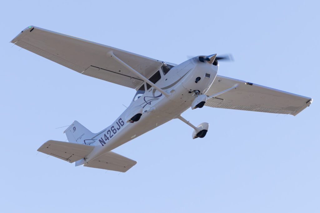 Small airplane flying in clear sky.