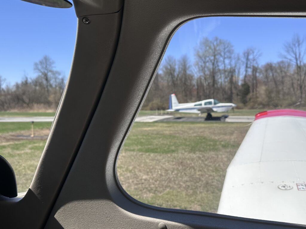 View of small airplane from cockpit window.
