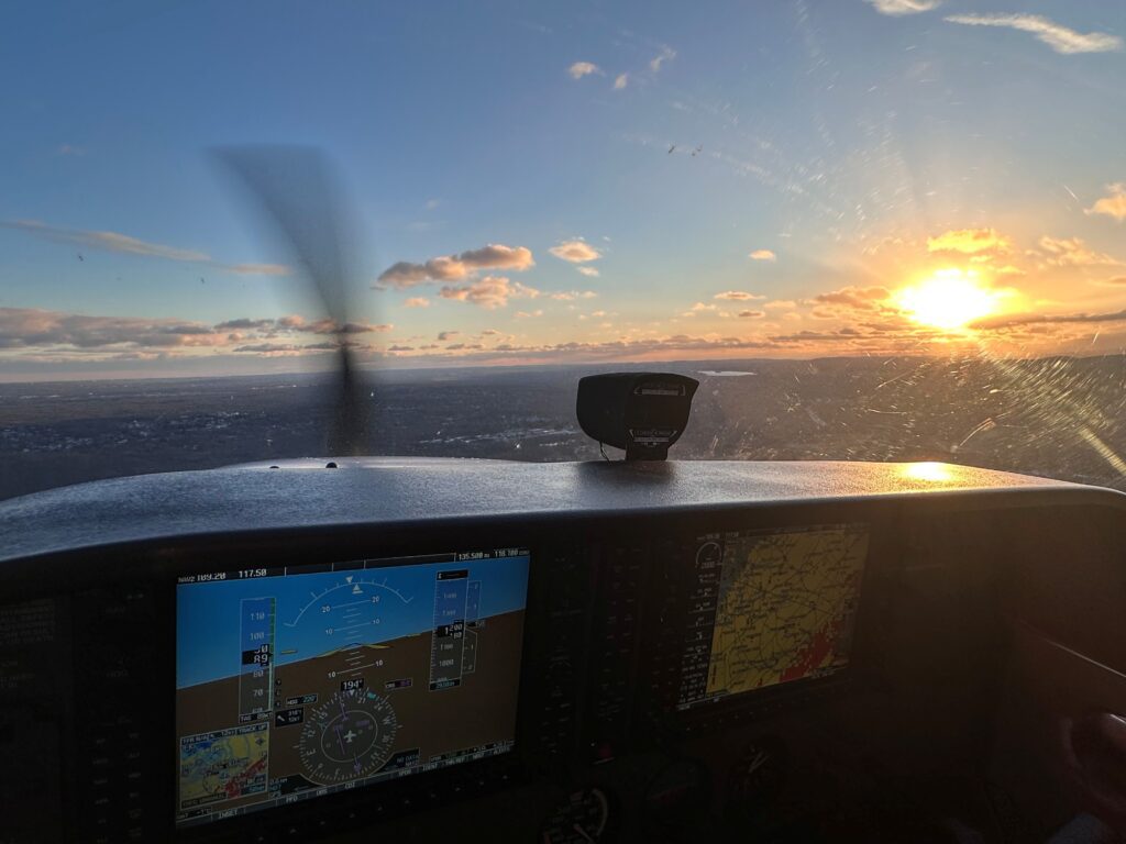 Cockpit view of sunset from airplane.