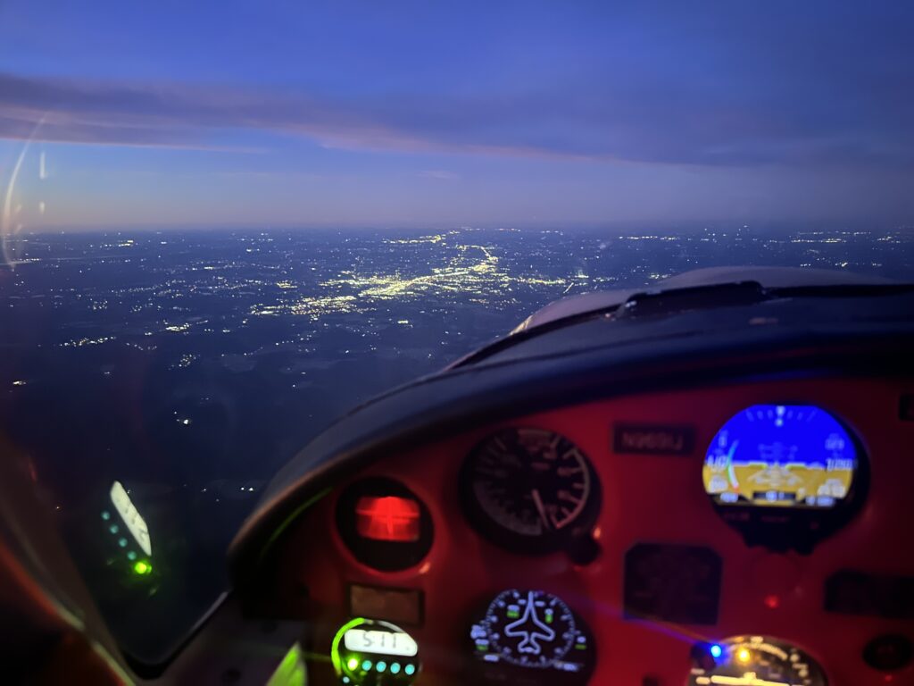 Nighttime aerial view from airplane cockpit.